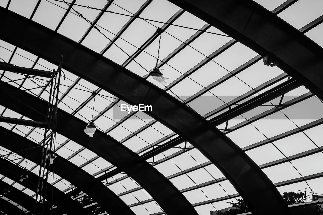 LOW ANGLE VIEW OF SKYLIGHT AGAINST SKY SEEN THROUGH GLASS