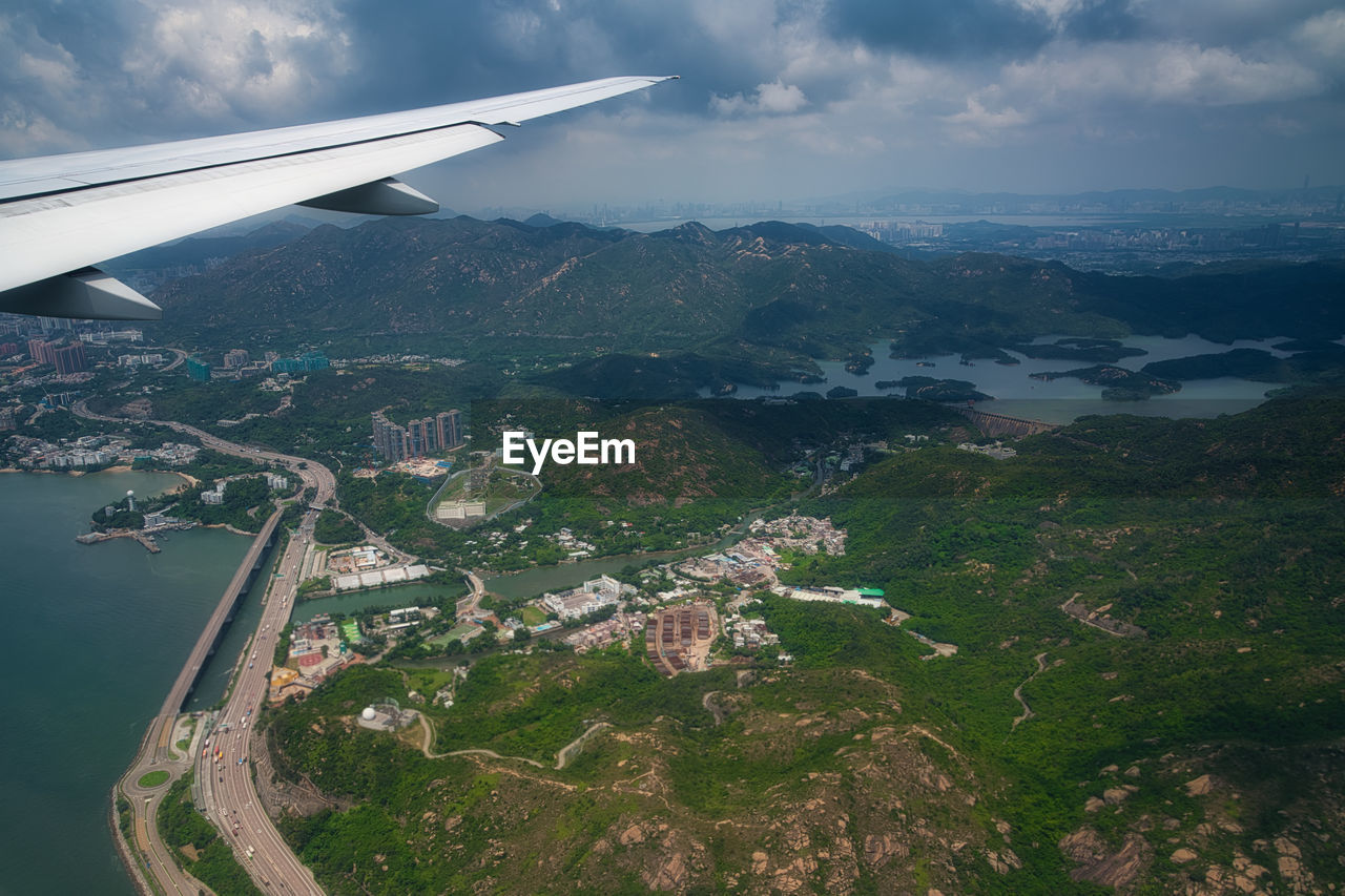 AERIAL VIEW OF CITYSCAPE AND AIRPLANE FLYING IN SKY