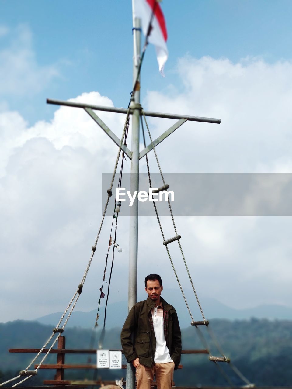 Man standing on boat against sky