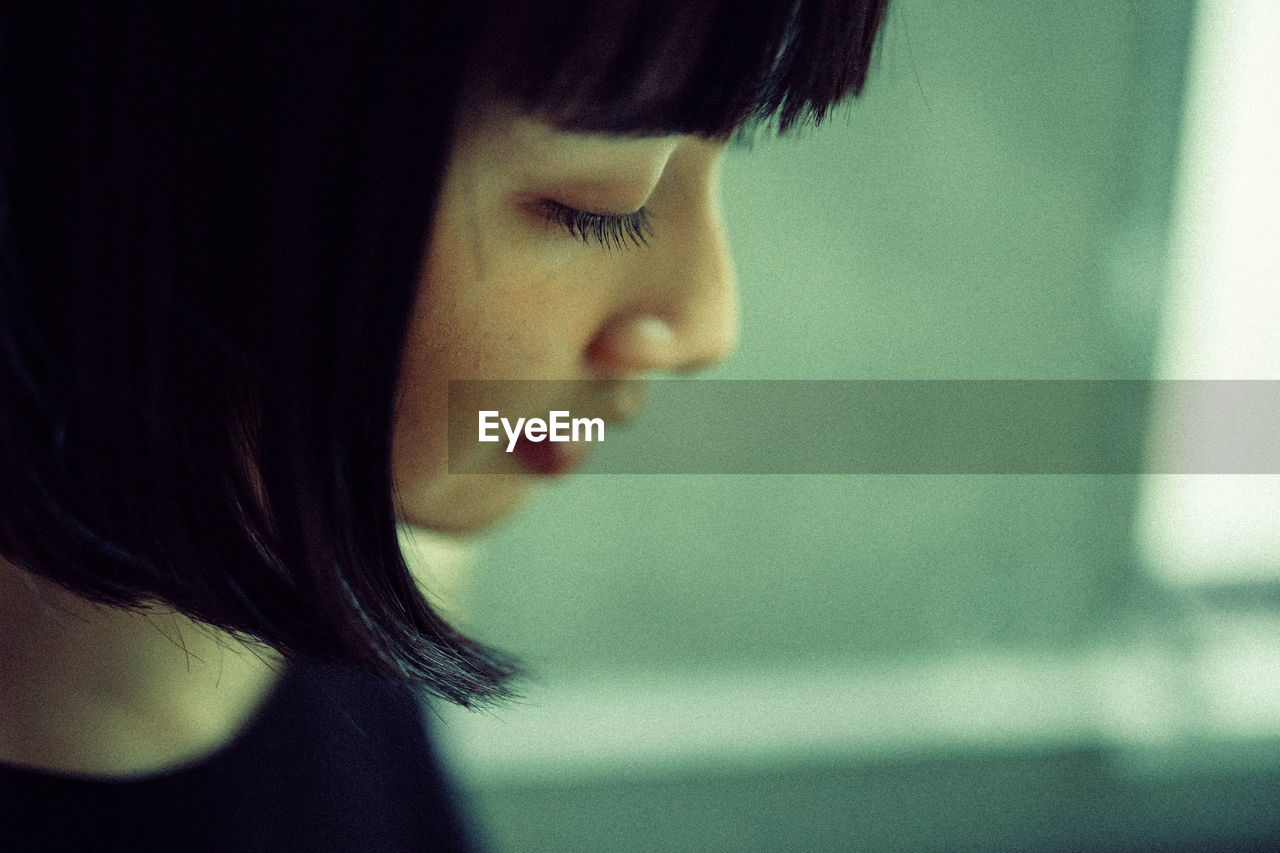 CLOSE-UP PORTRAIT OF A YOUNG WOMAN WITH EYES