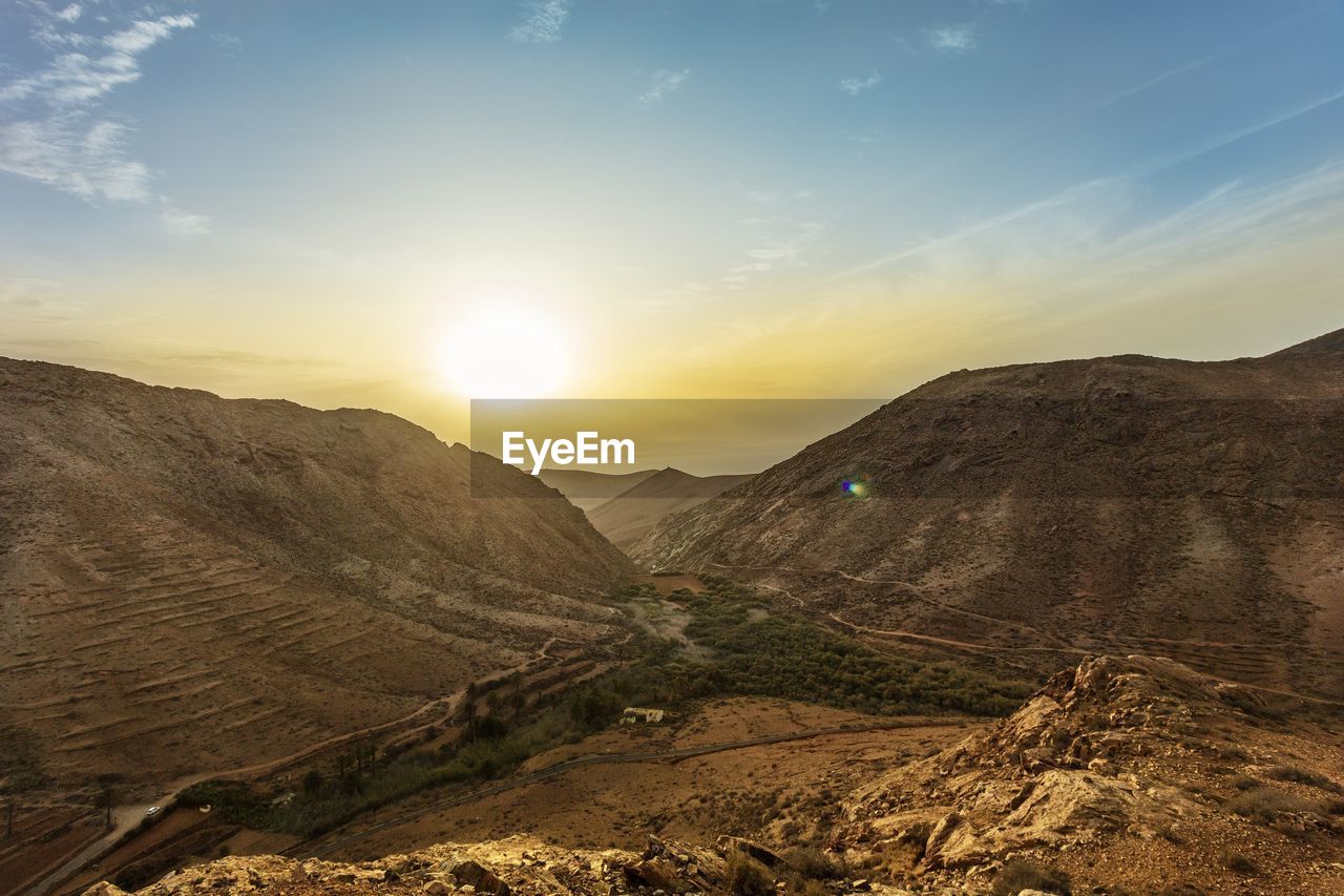 Scenic view of mountains against sky during sunset