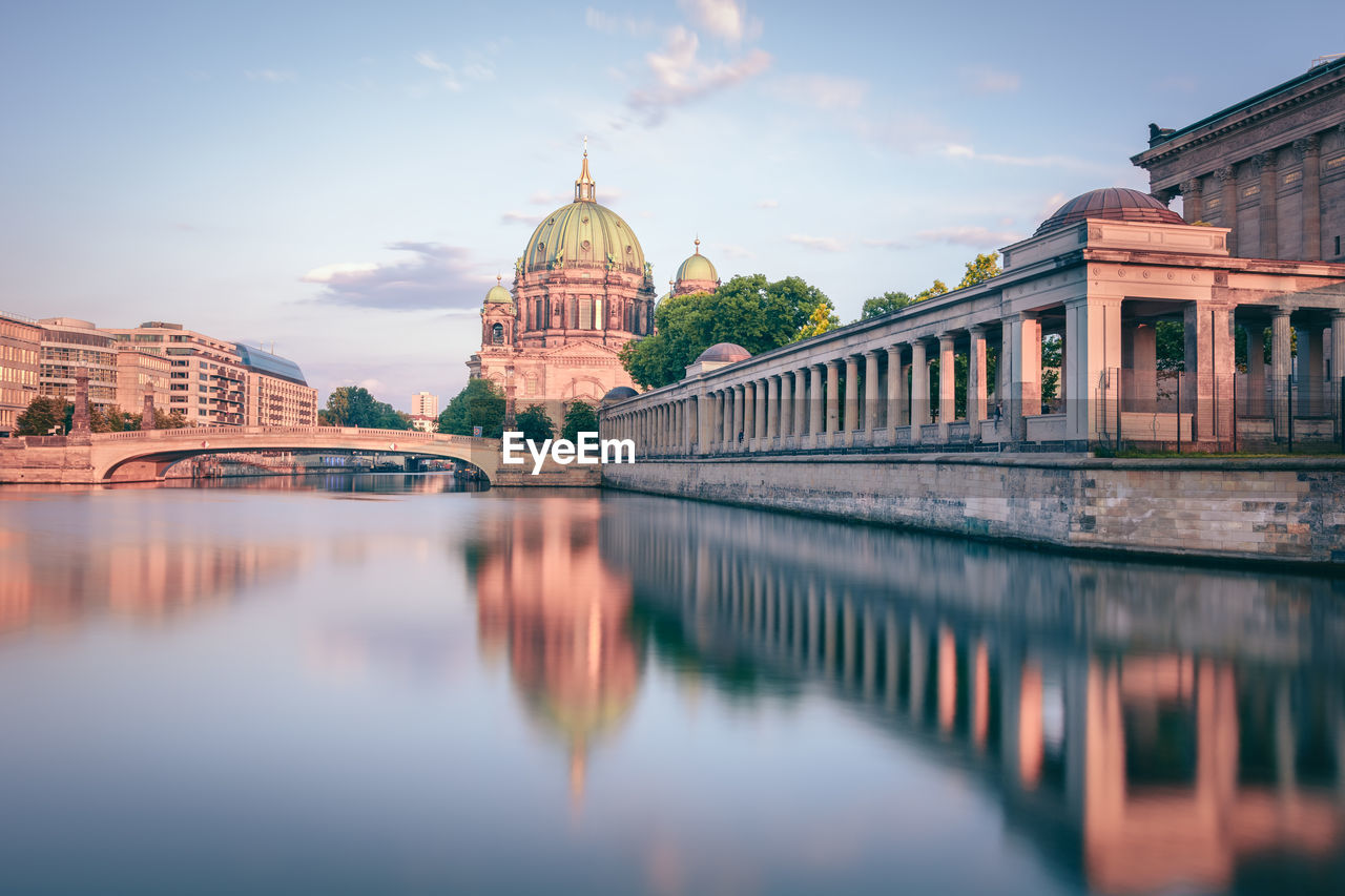 Berlin cathedral in city by spree river against sky