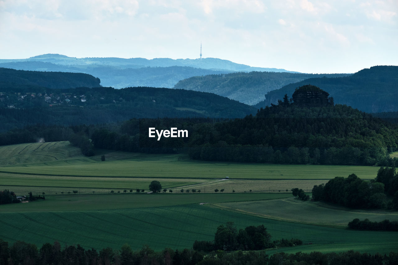 Scenic view of landscape and mountains against sky