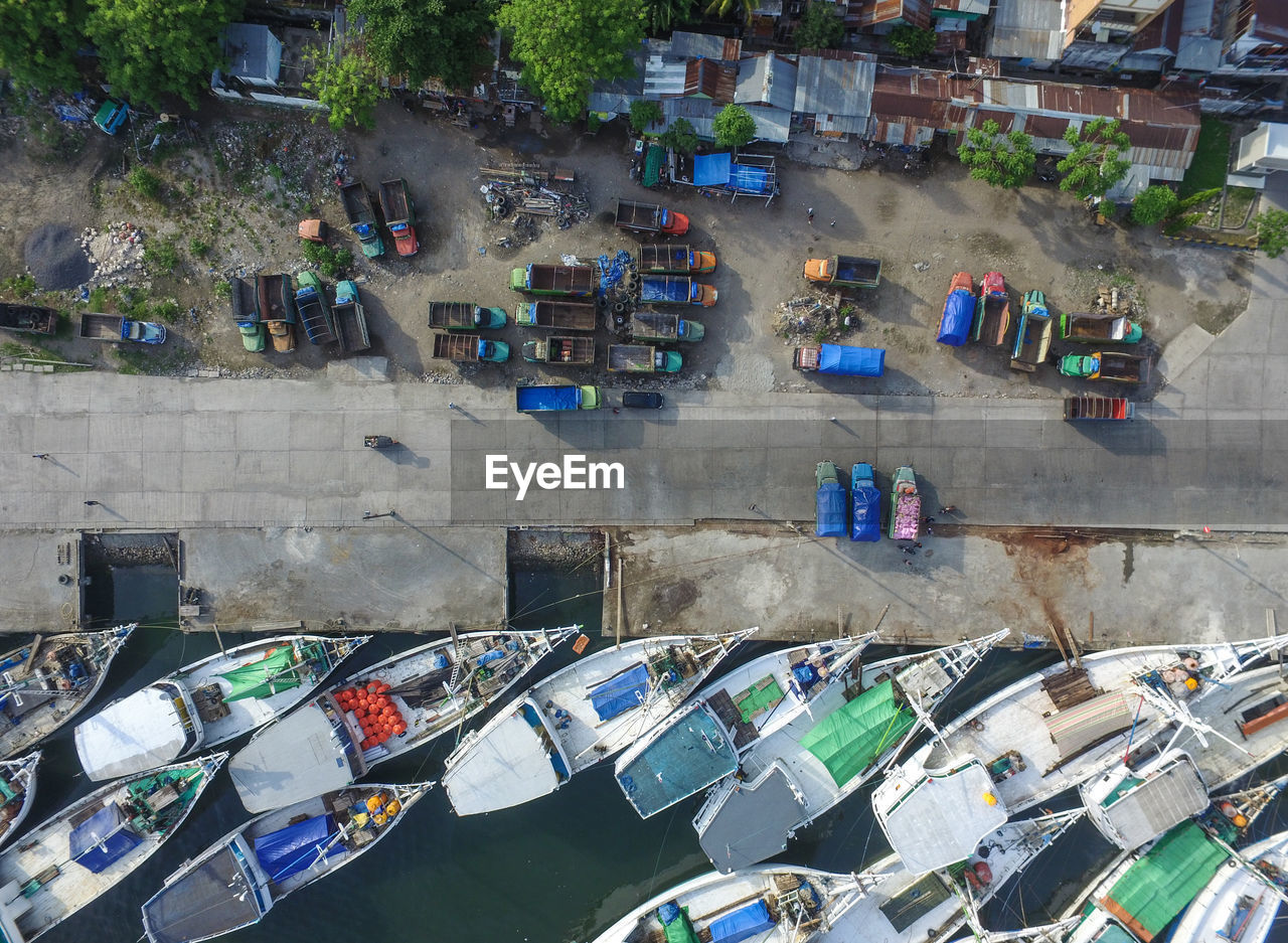 Aerial view of boats moored on pier at harbor