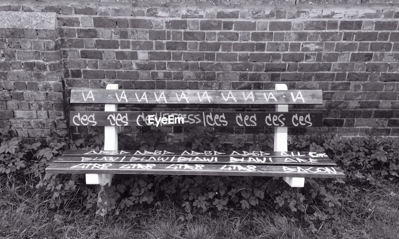 White graffiti on a park bench in gent