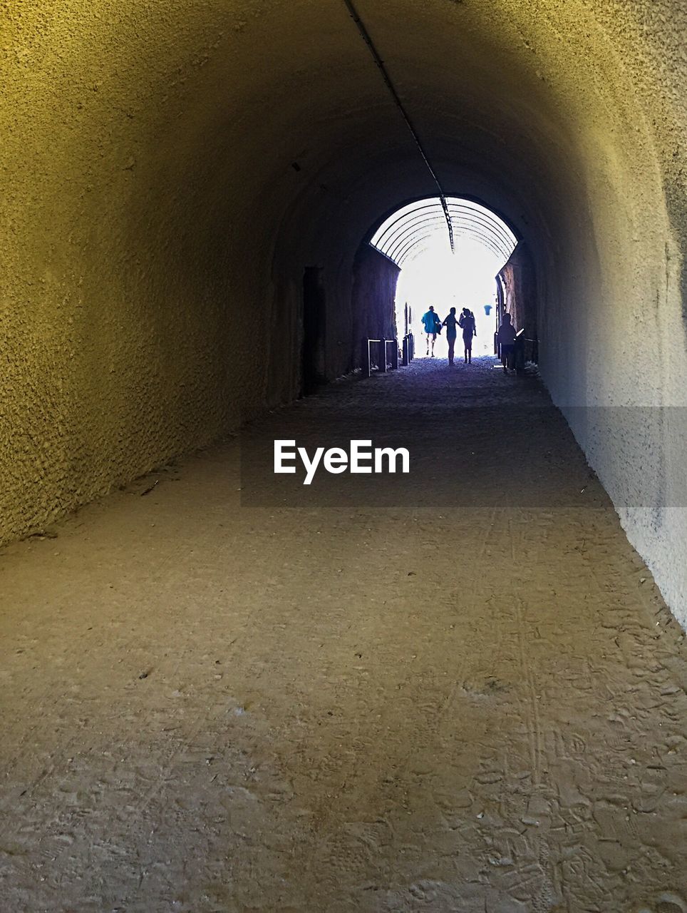 WOMAN WALKING IN TUNNEL