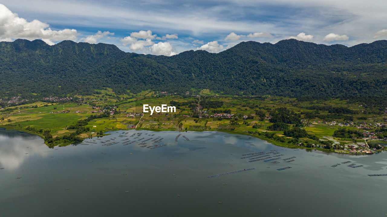 high angle view of lake and mountains against sky