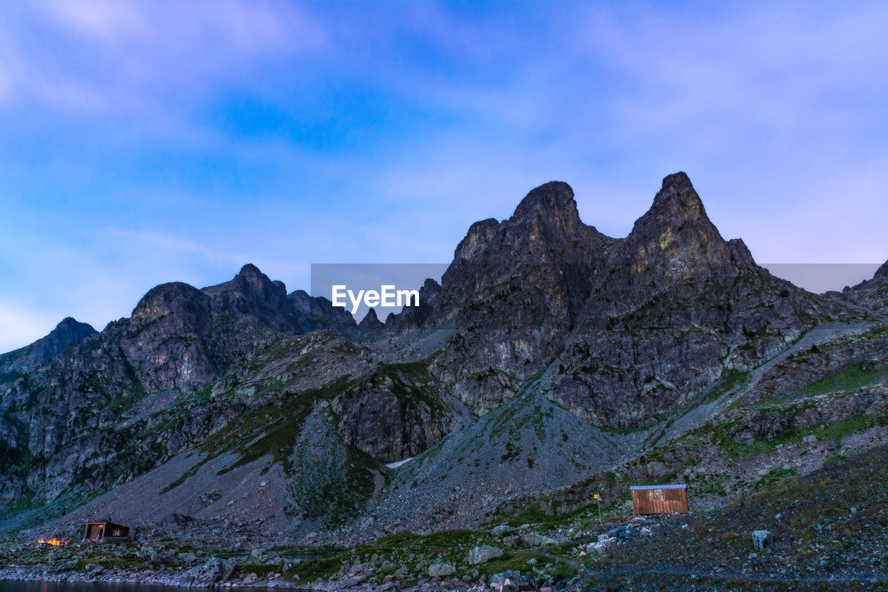 Scenic view of mountain against blue sky