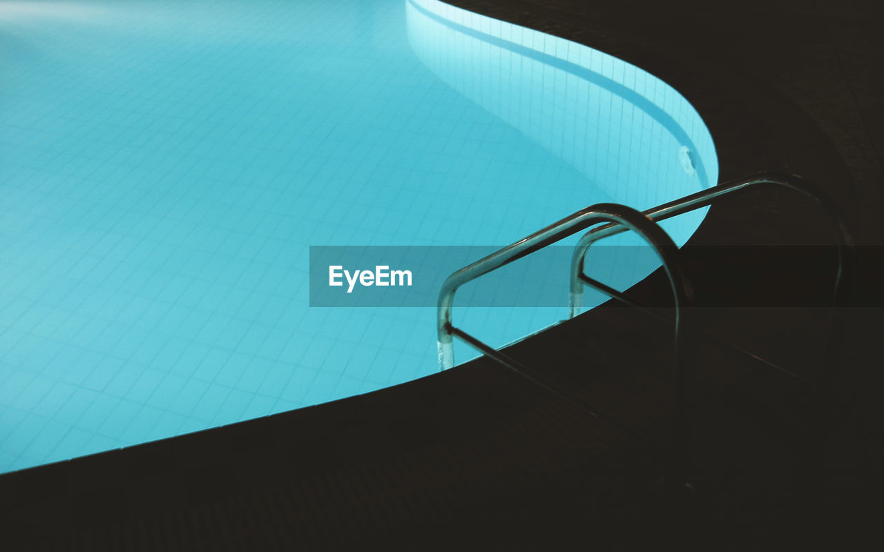 Empty swimming pool at night