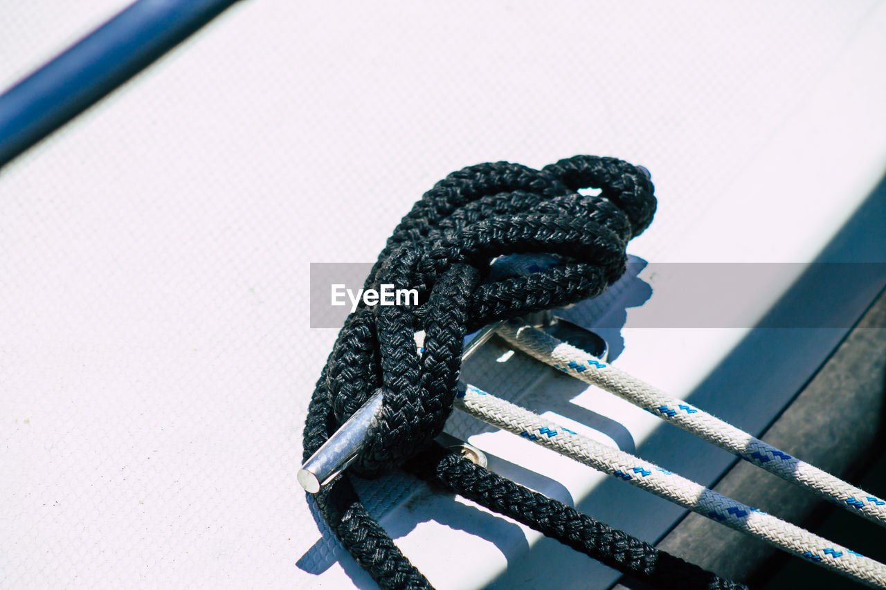 HIGH ANGLE VIEW OF ROPE TIED UP ON METALLIC STRUCTURE