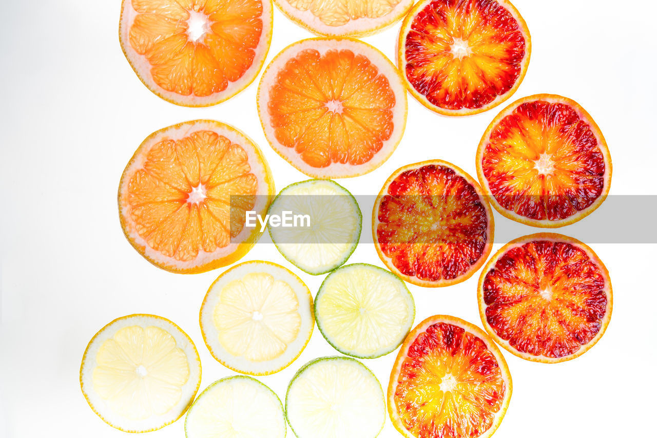 Slices of citrus fruit on white background