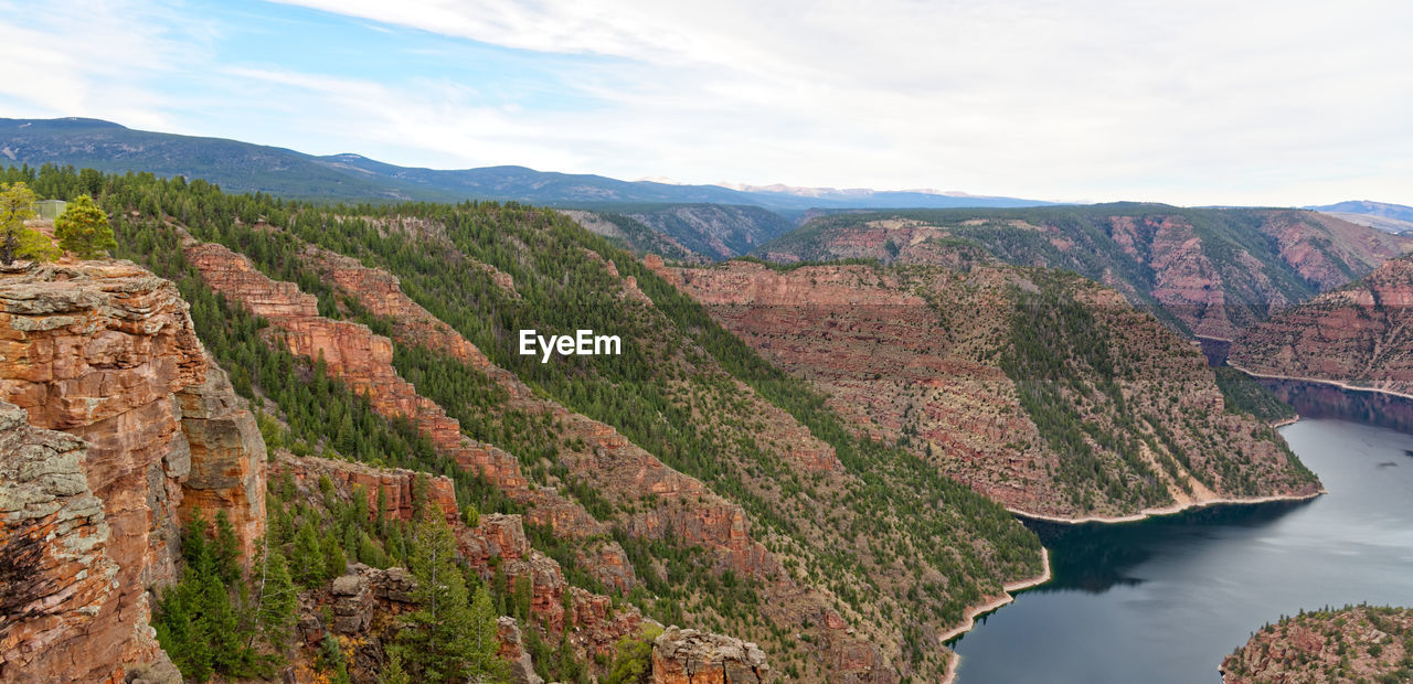 SCENIC VIEW OF RIVER AMIDST MOUNTAINS AGAINST SKY