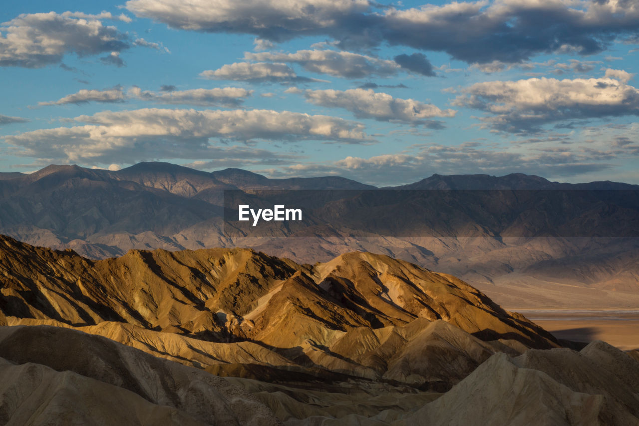 Scenic view of mountains against cloudy sky