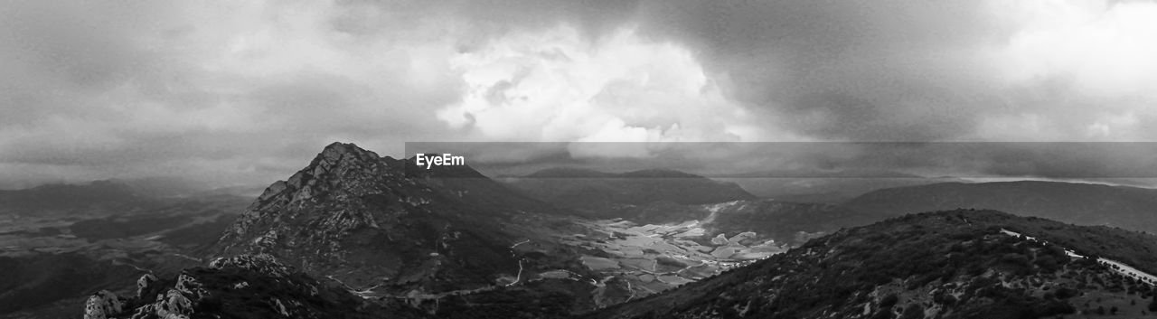 Panoramic view of mountains against sky in bw