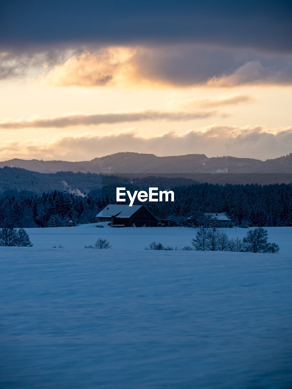 SCENIC VIEW OF SNOWCAPPED MOUNTAINS DURING SUNSET