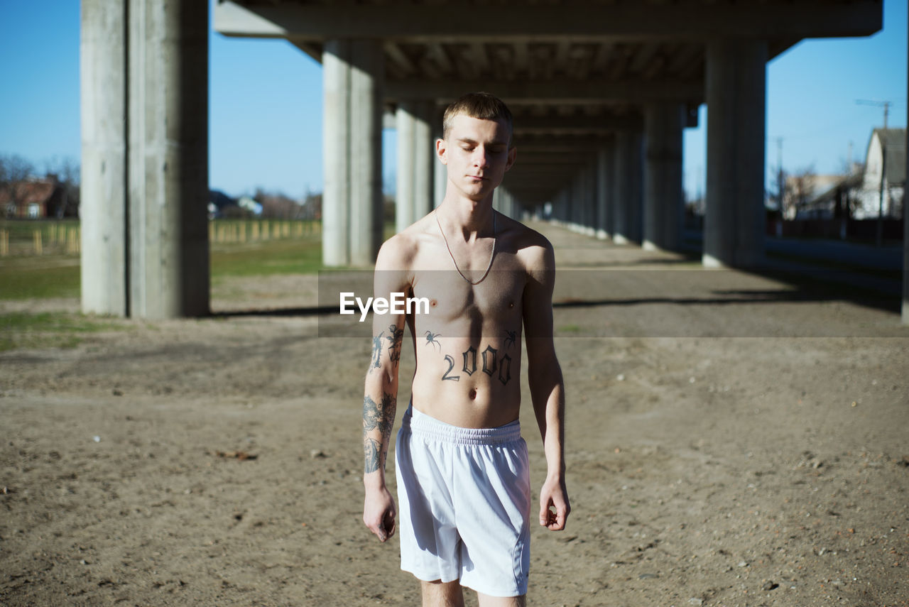 Shirtless young man outdoors