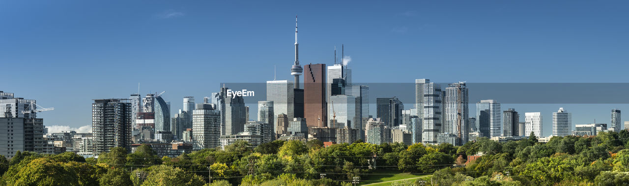 PANORAMIC VIEW OF MODERN BUILDINGS AGAINST SKY