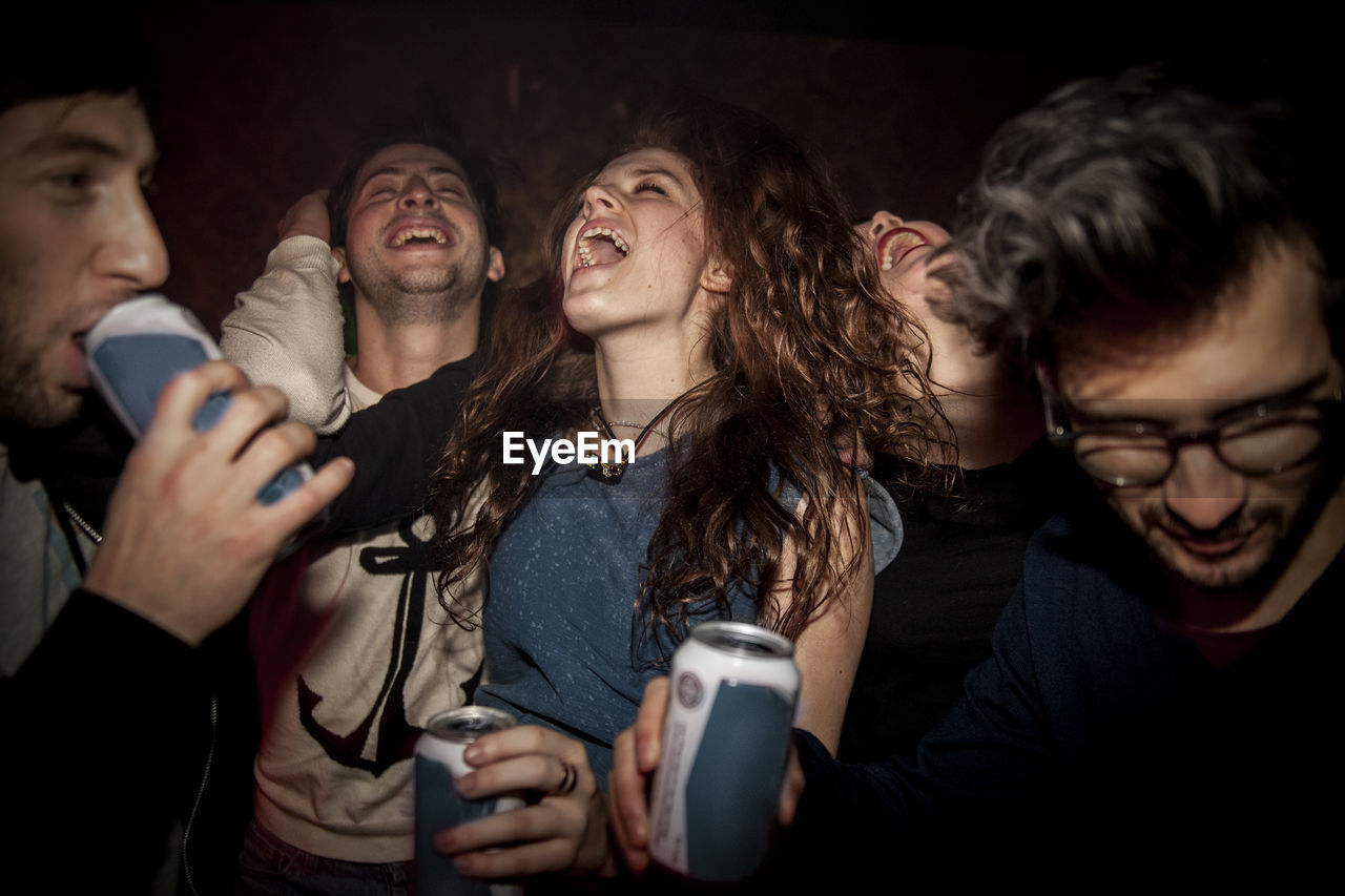 Young people enjoying music concert at night