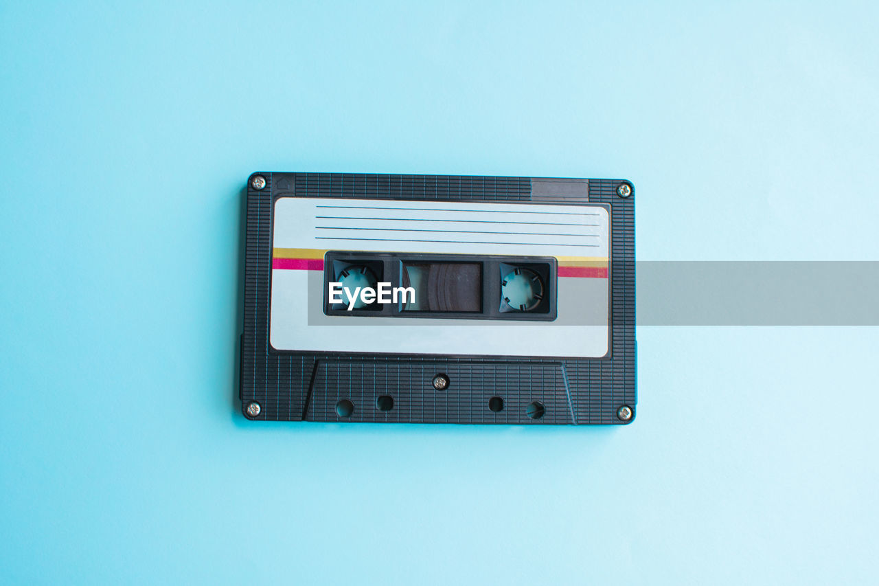 Directly above shot of audio cassette on blue background