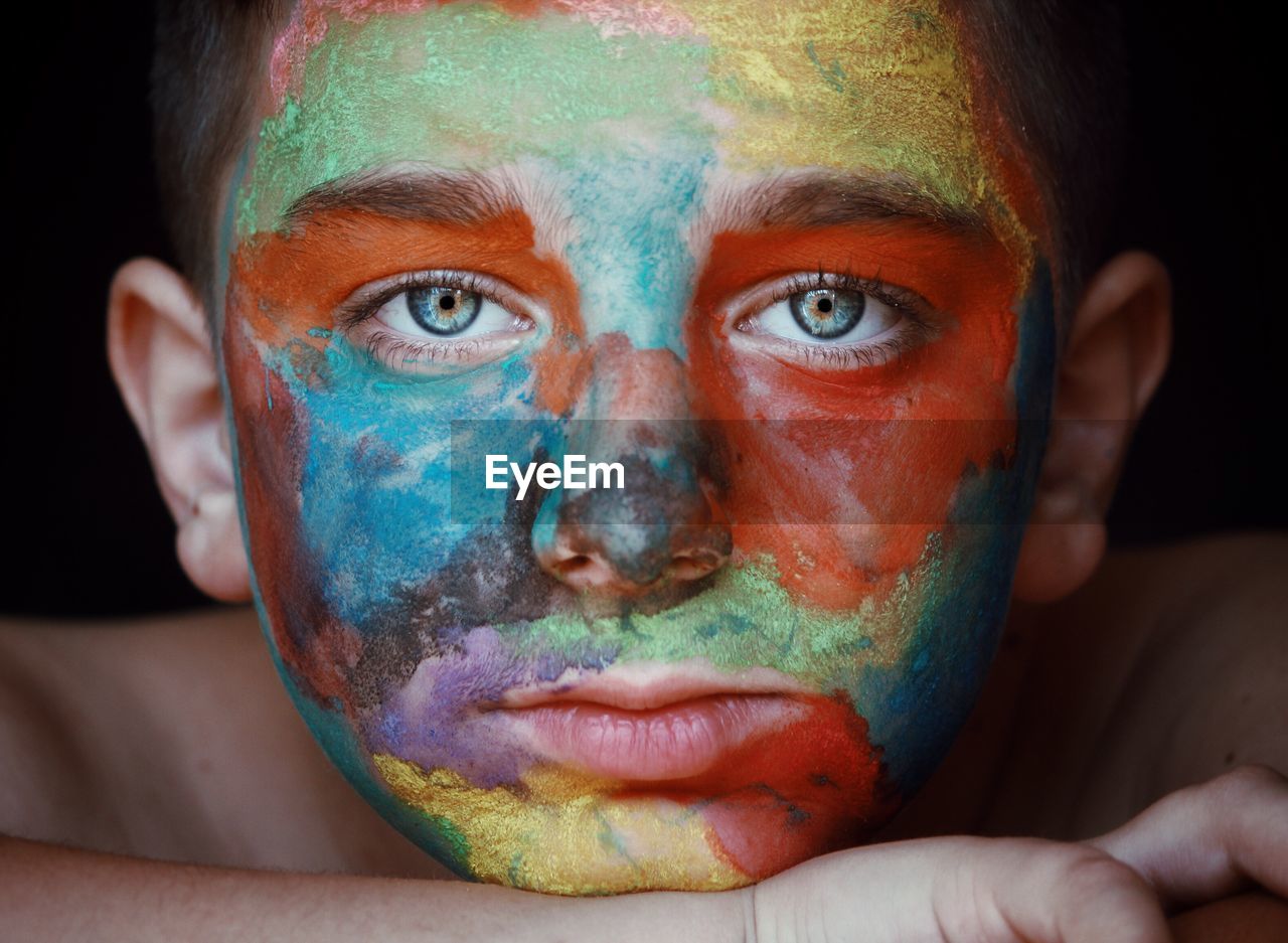 Close-up portrait of boy with face paint