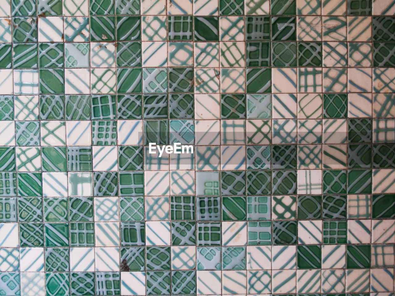 Full frame shot of green and white patterned tile wall