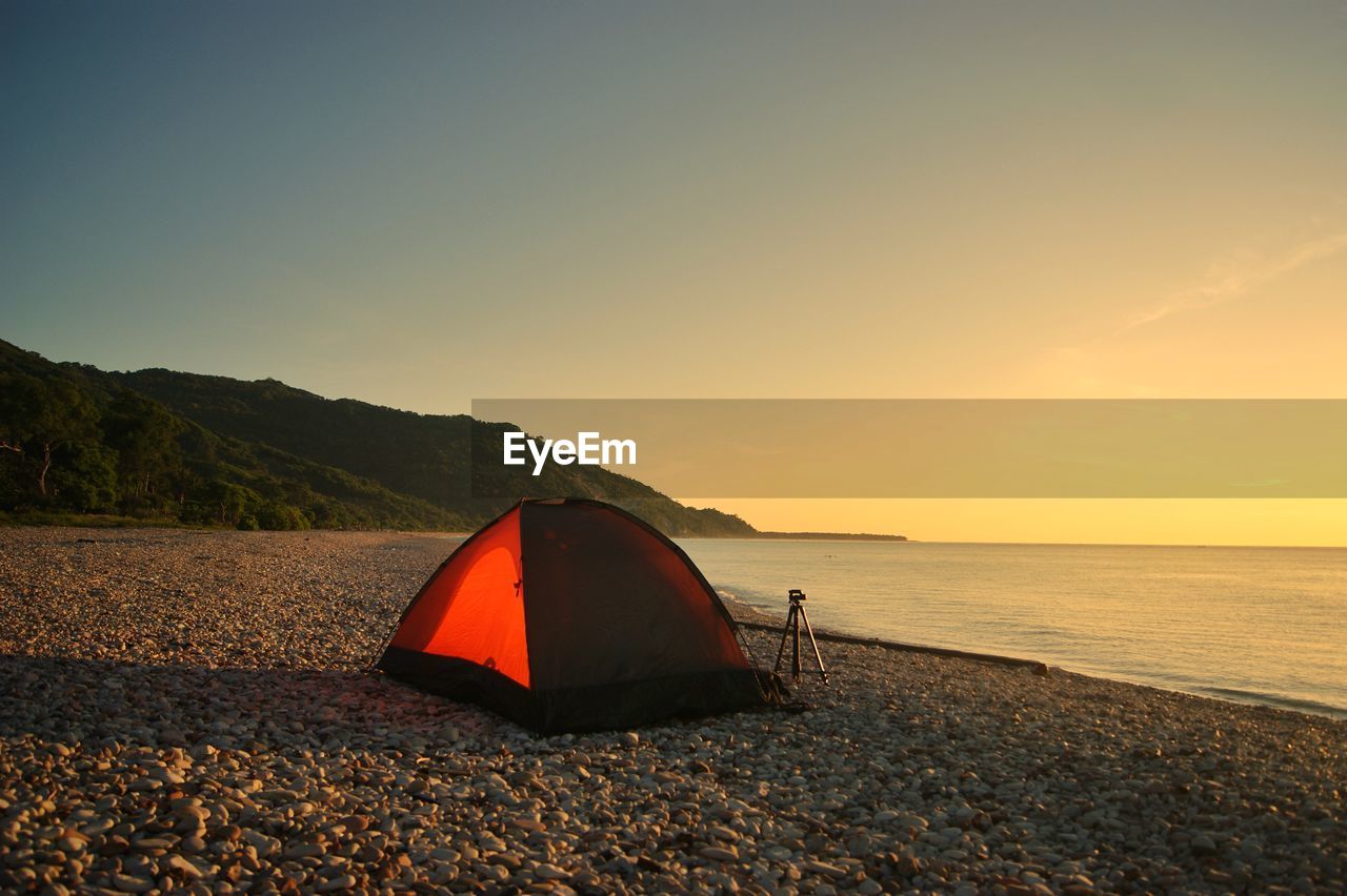 Scenic view of beach against sky during sunrise