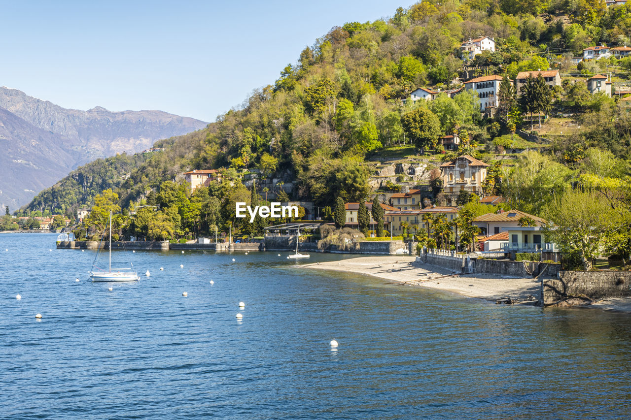 The colmegna coast in the lake maggiore with its beach and its villas