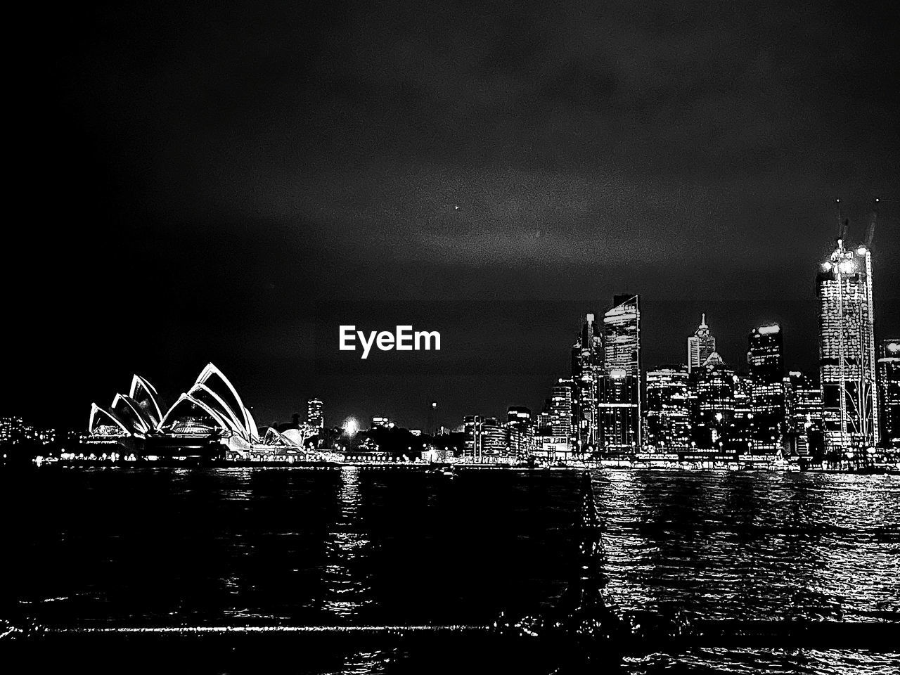 architecture, night, black and white, built structure, skyline, building exterior, water, city, travel destinations, sky, darkness, monochrome photography, building, illuminated, cityscape, monochrome, nature, no people, skyscraper, urban skyline, office building exterior, landscape, horizon, travel, outdoors, reflection, river, tower, tourism