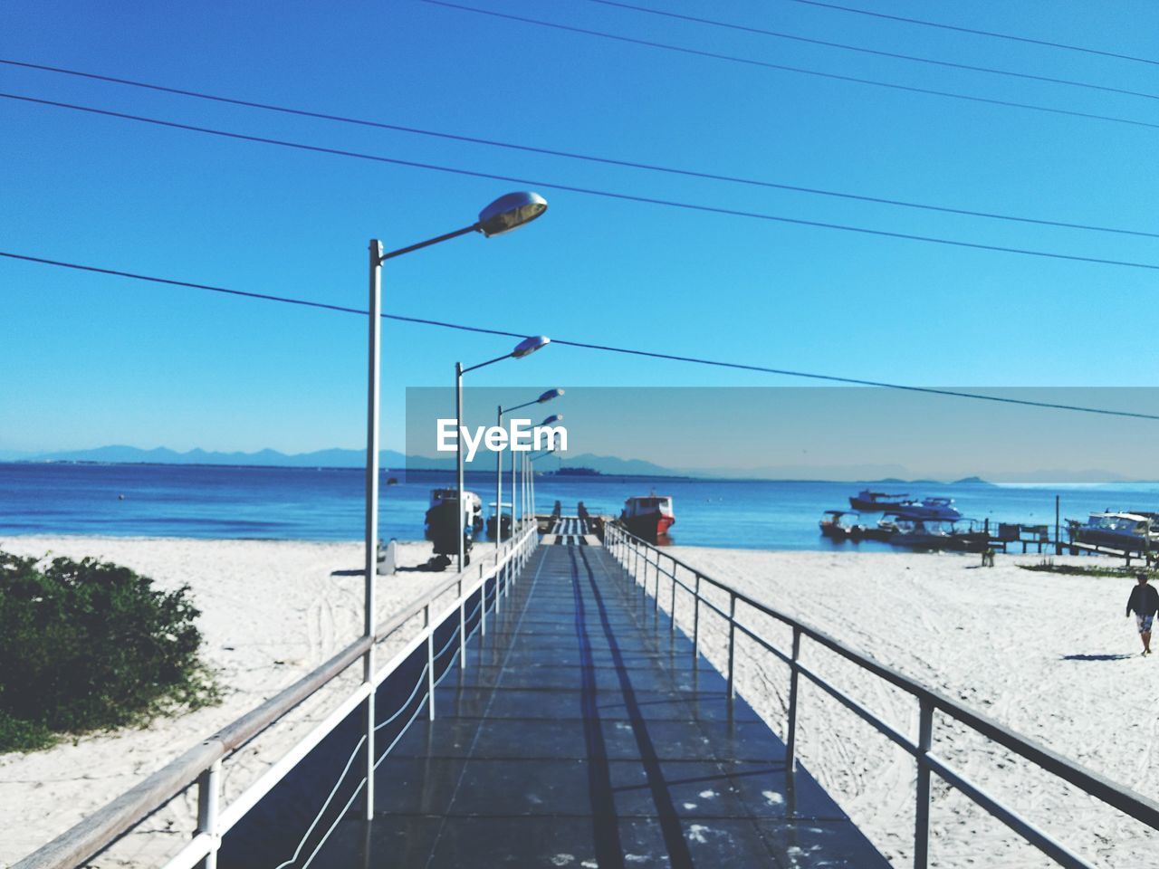 Scenic view of sea against clear blue sky