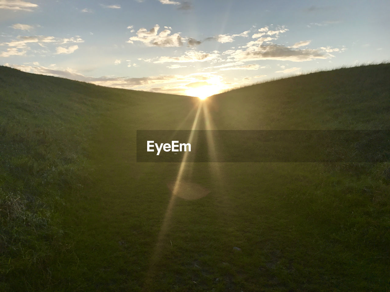 SCENIC VIEW OF LANDSCAPE AGAINST SKY DURING SUNSET