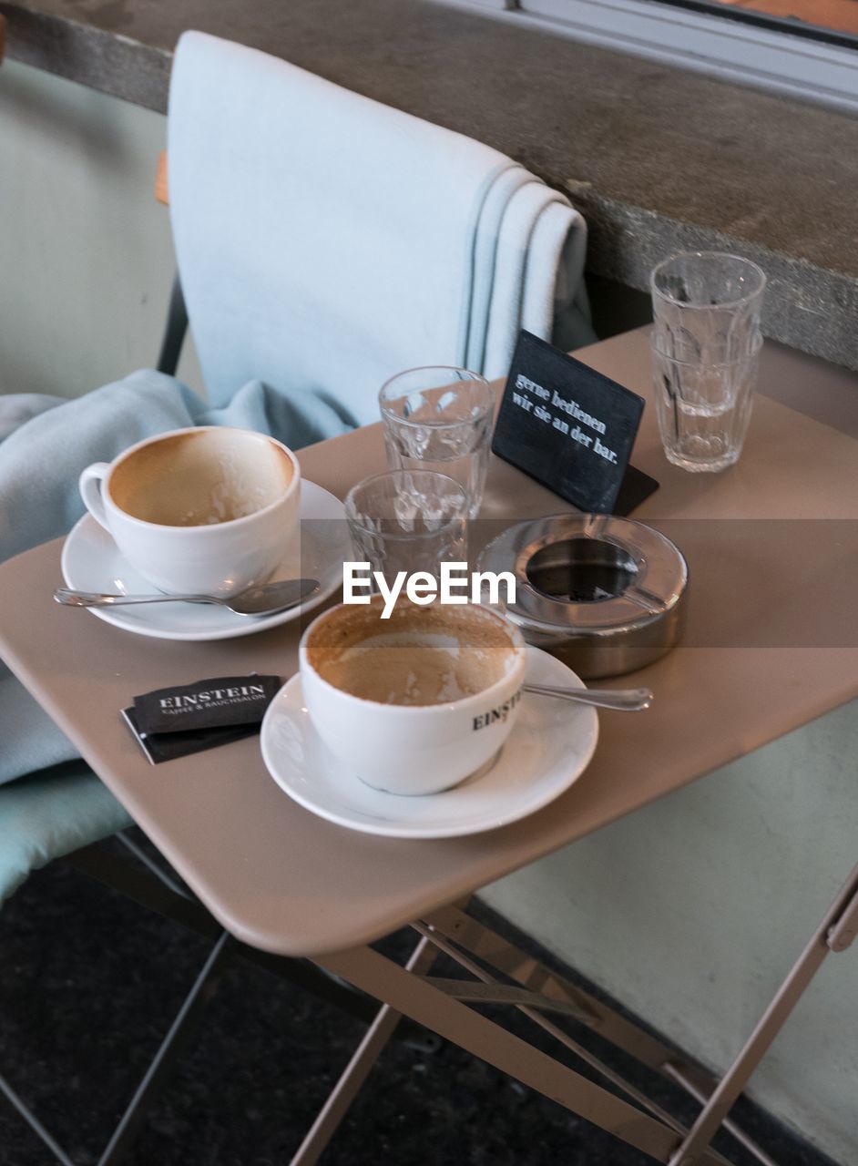 HIGH ANGLE VIEW OF COFFEE ON TABLE AT HOME