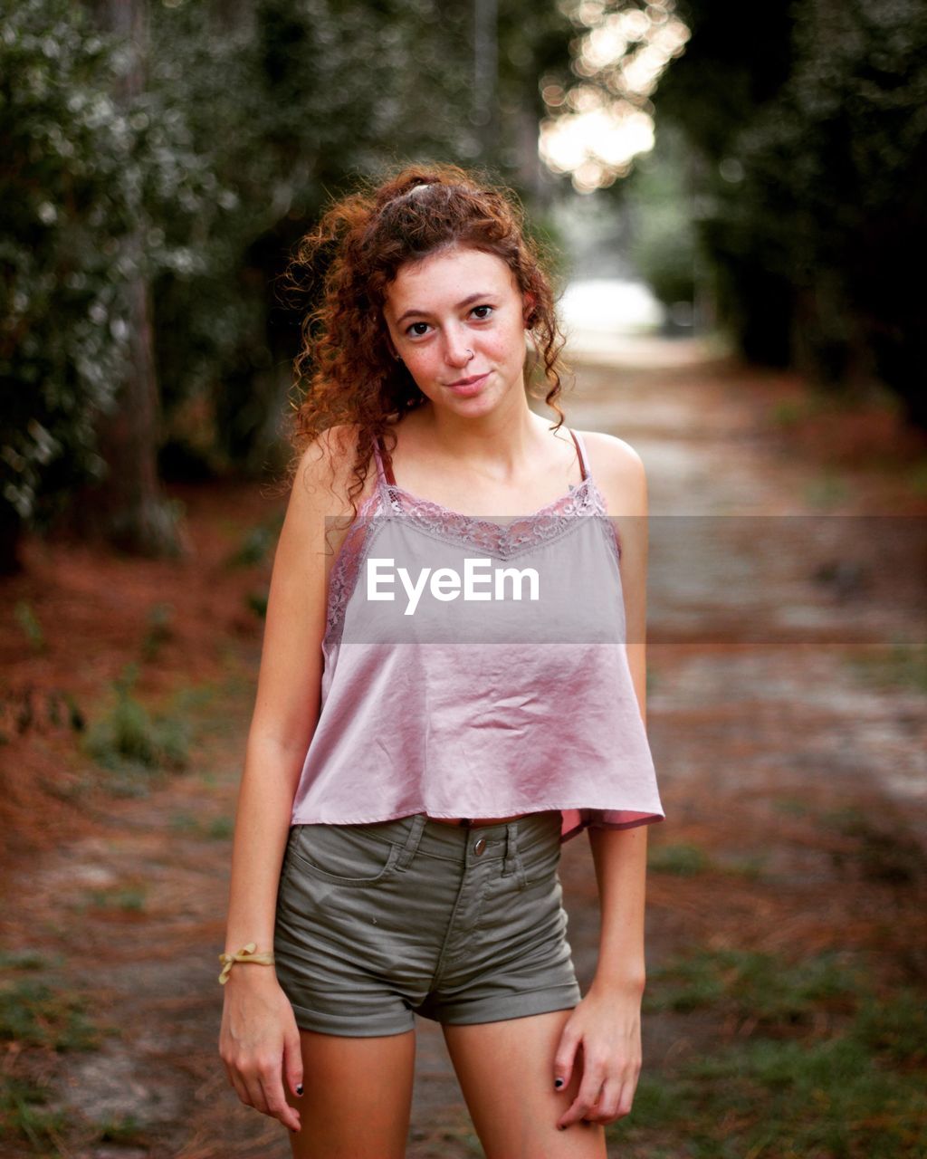 PORTRAIT OF SMILING GIRL STANDING ON LAND