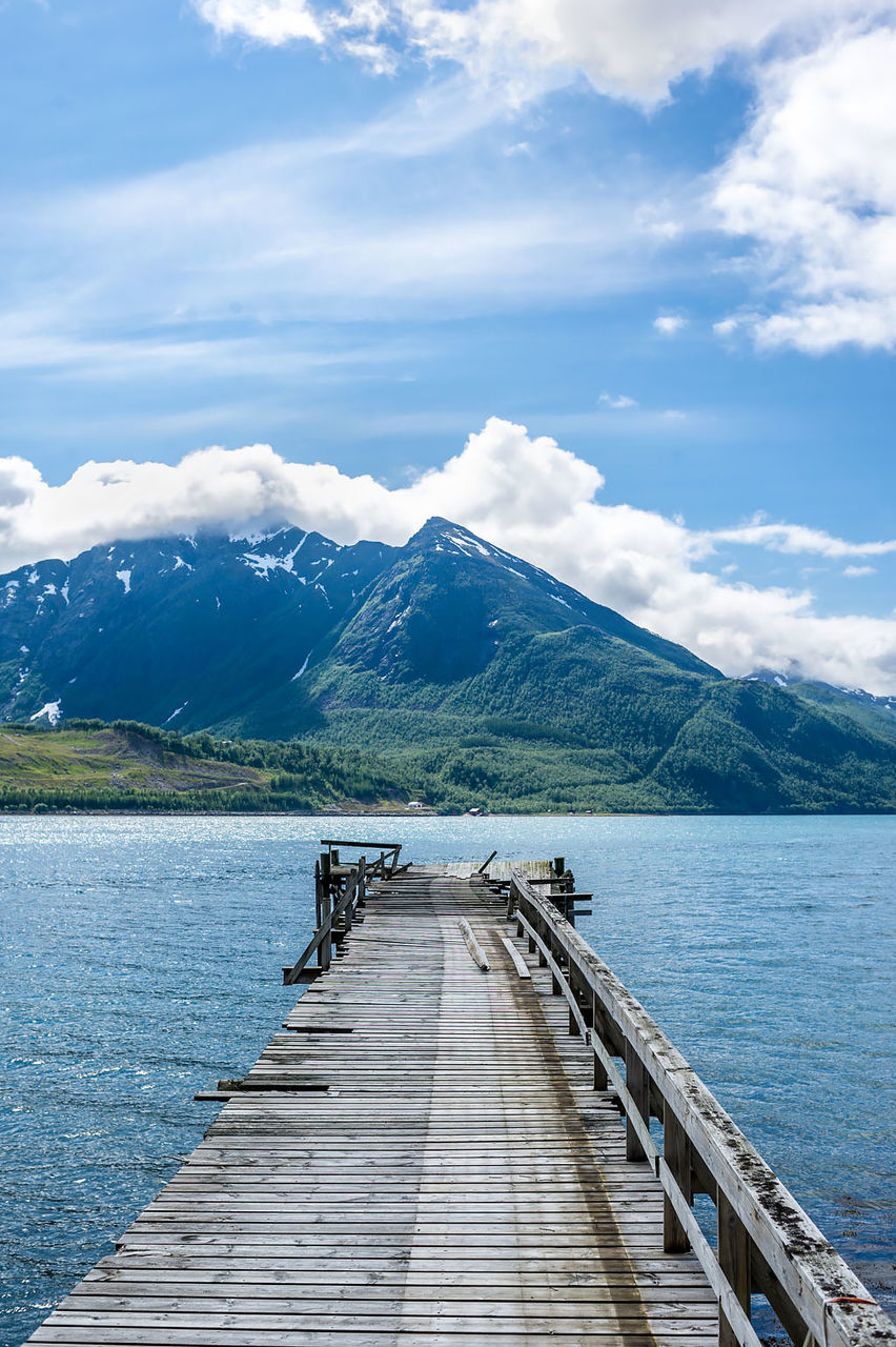 View of pier on lake against cloudy sky