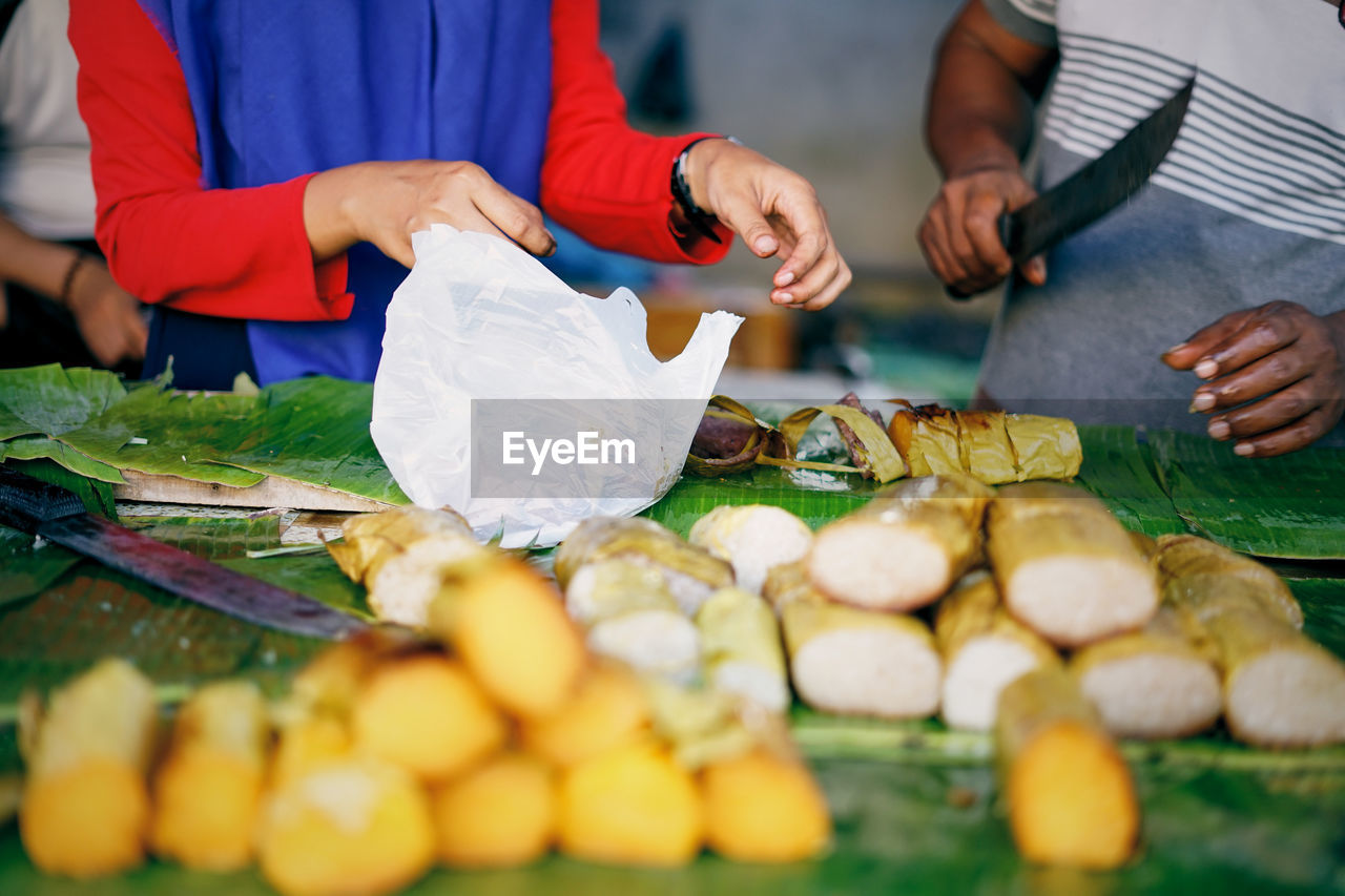 Vendor seling grilled sticky rice  at street food market