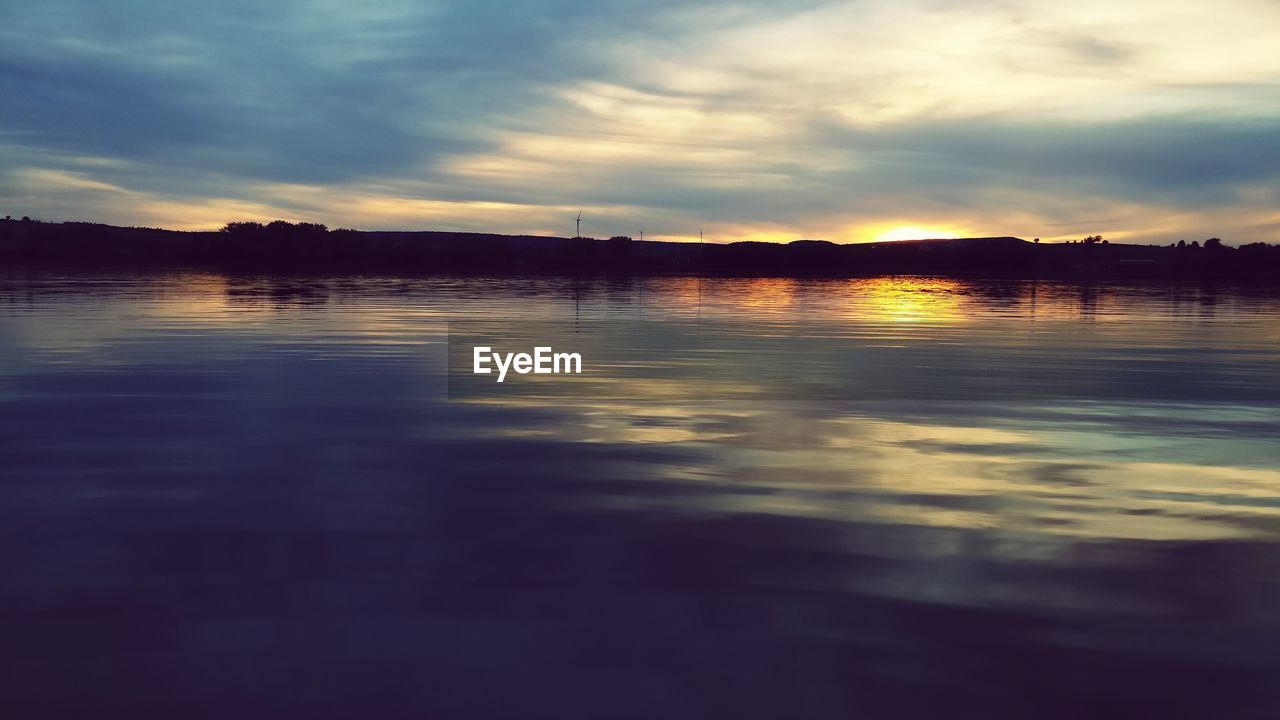 SCENIC VIEW OF LAKE AT SUNSET