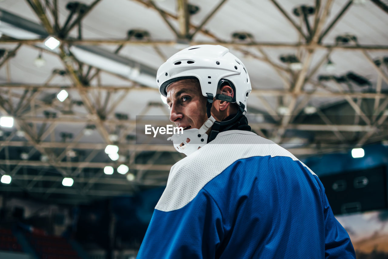 Rear view of man playing hockey