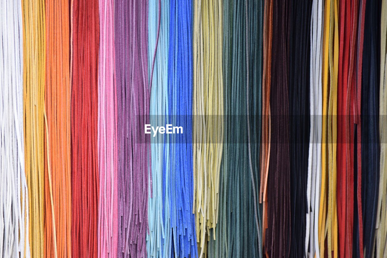 Full frame shot of colorful strings hanging in store