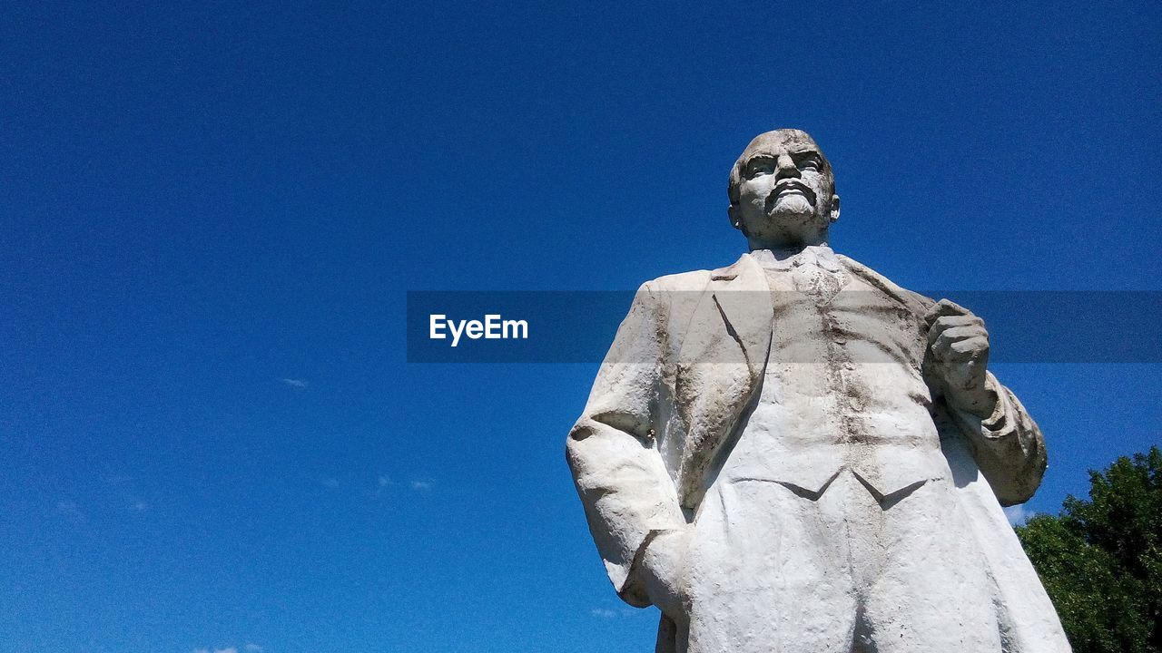 Low angle view of statue against clear blue sky