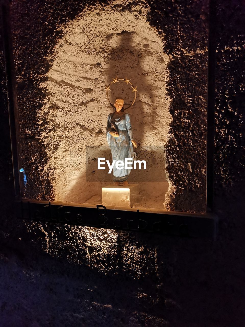 WOMAN STANDING AGAINST WALL