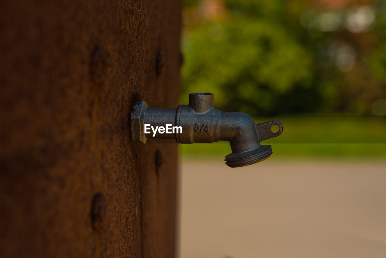 Close-up of faucet against wall