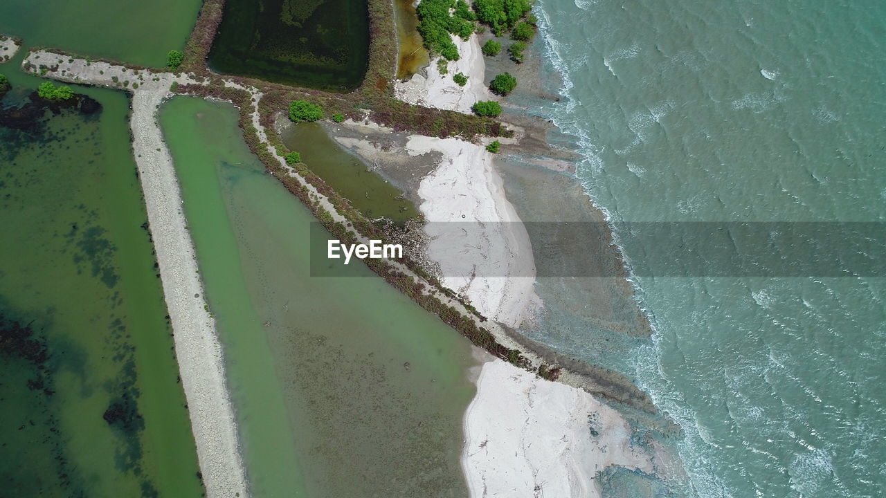 HIGH ANGLE VIEW OF SURF ON BEACH