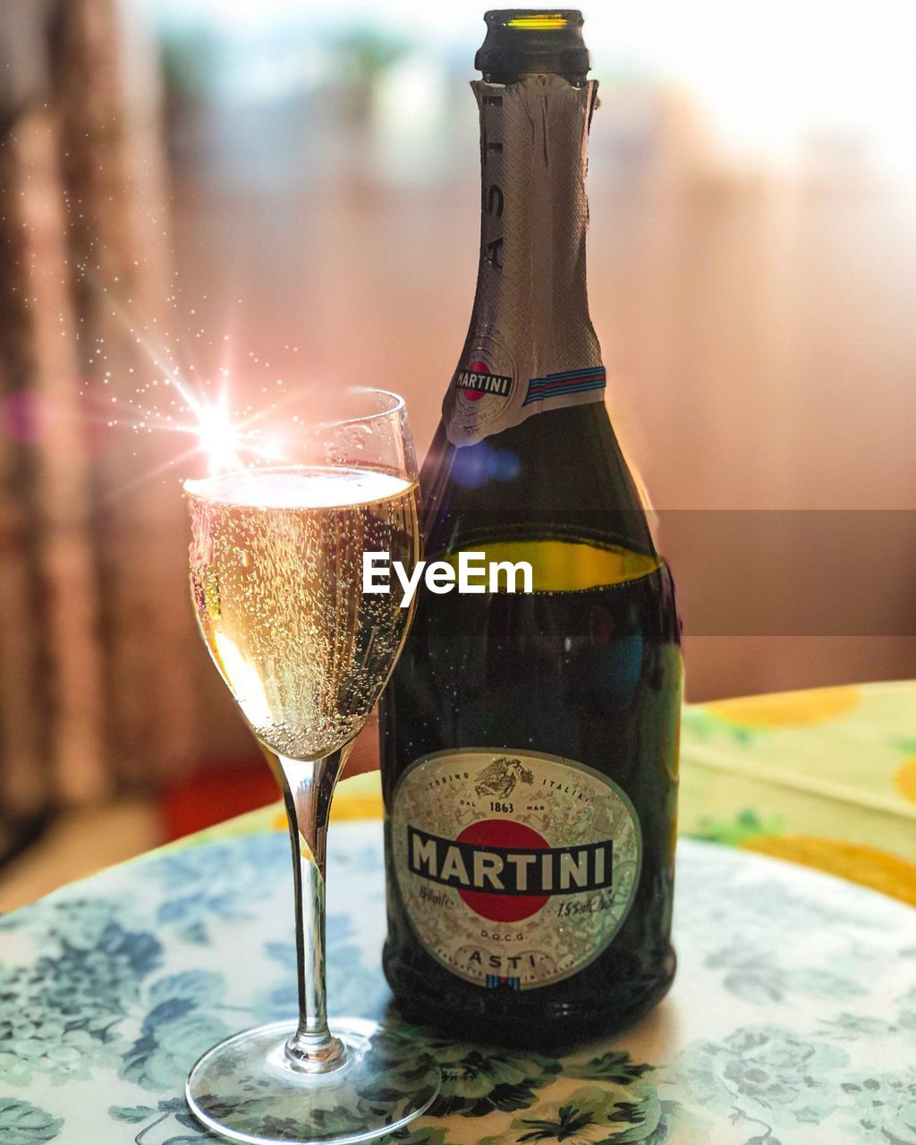 CLOSE-UP OF BEER GLASS WITH BOTTLE ON TABLE