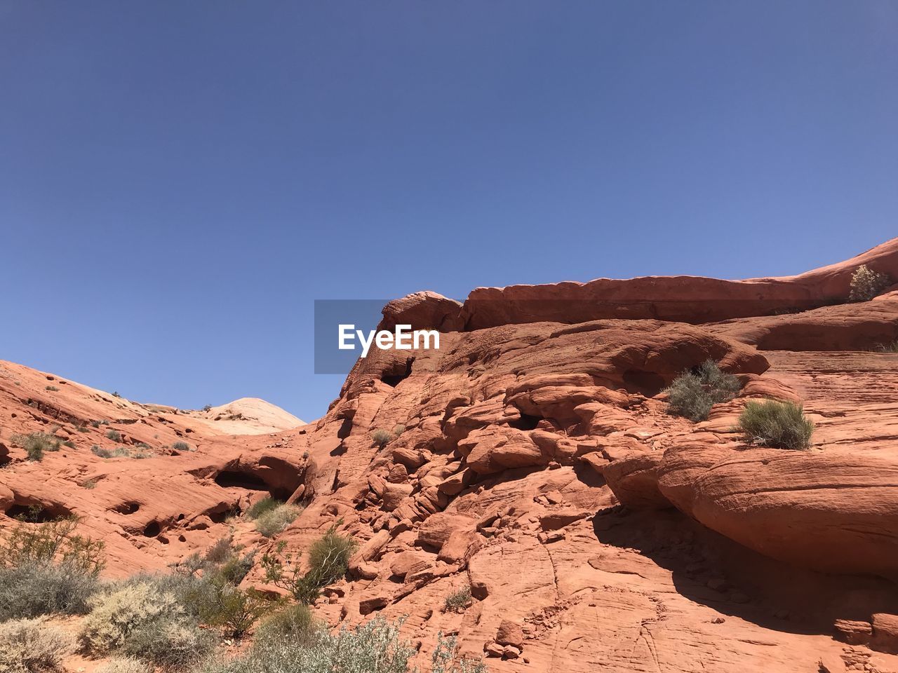 Rock formations on mountain against clear sky