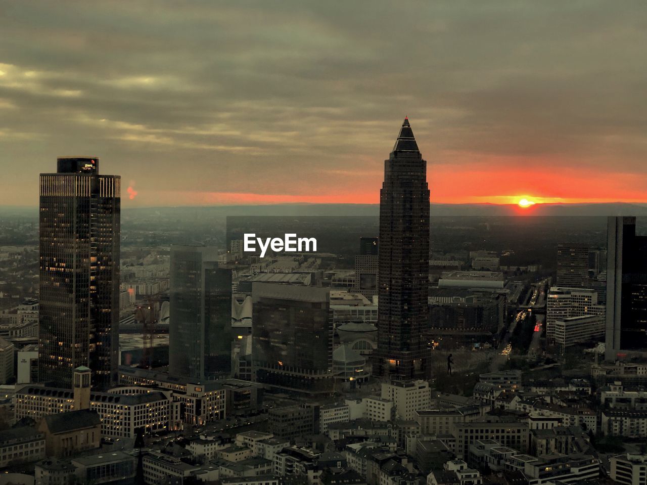 Aerial view of buildings in city at sunset