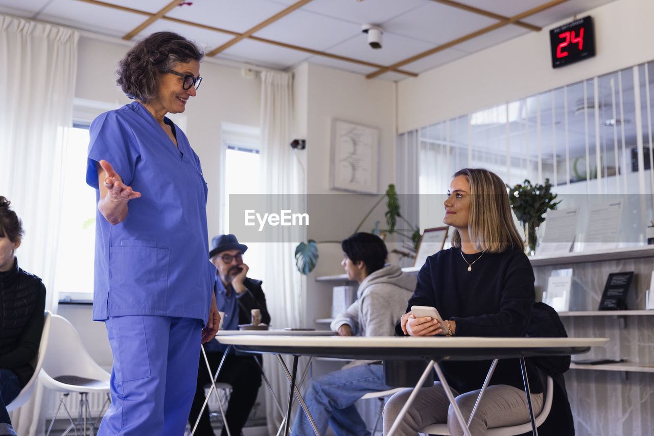 Doctor talking to patient in waiting room