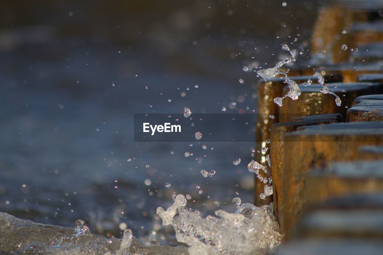 Close-up of water splashing on glass