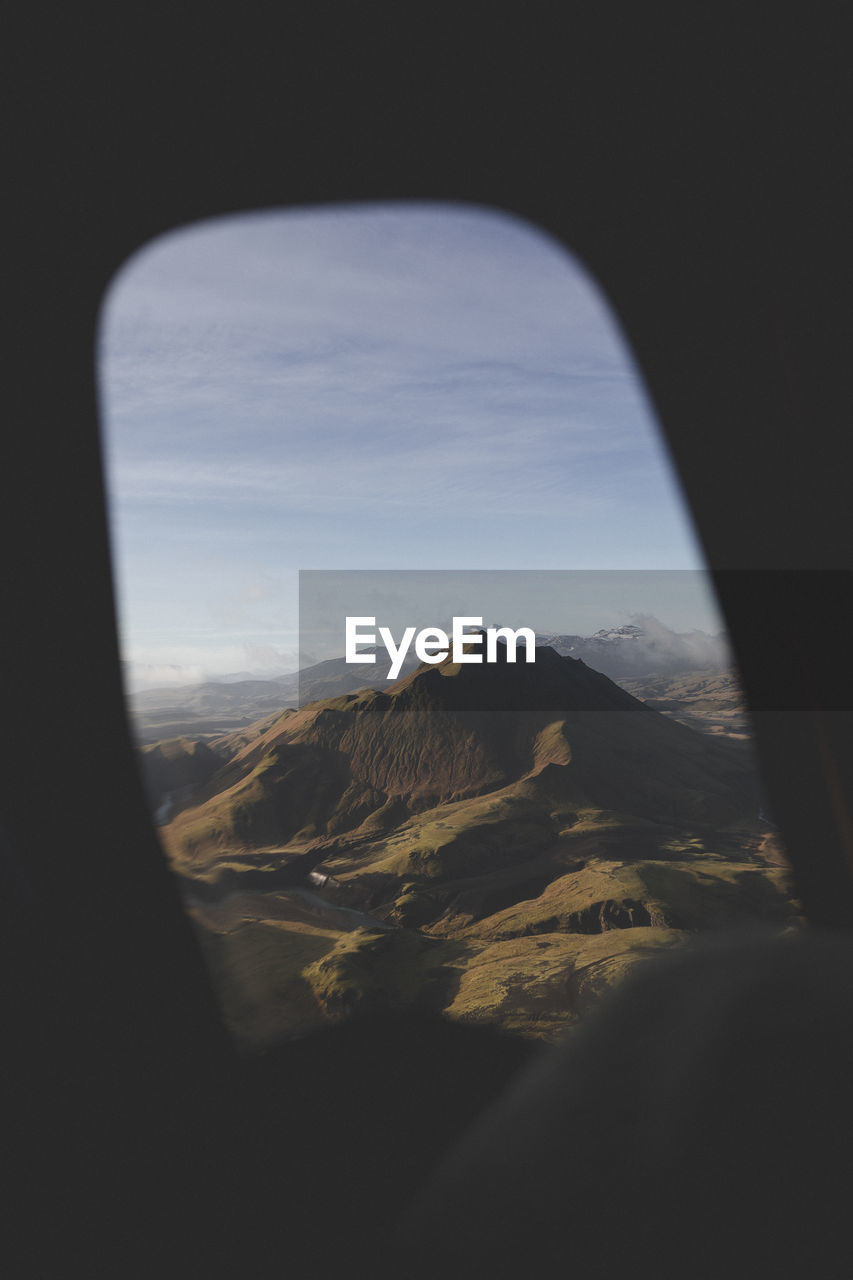 SCENIC VIEW OF MOUNTAINS AGAINST SKY SEEN FROM WINDSHIELD