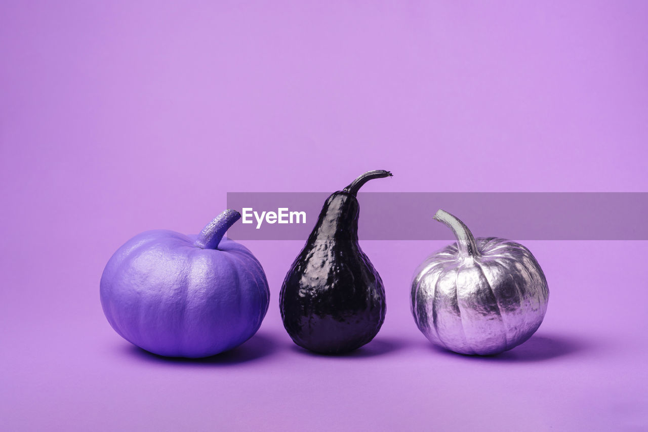 Multi-colored, different pumpkins, on a purple background
