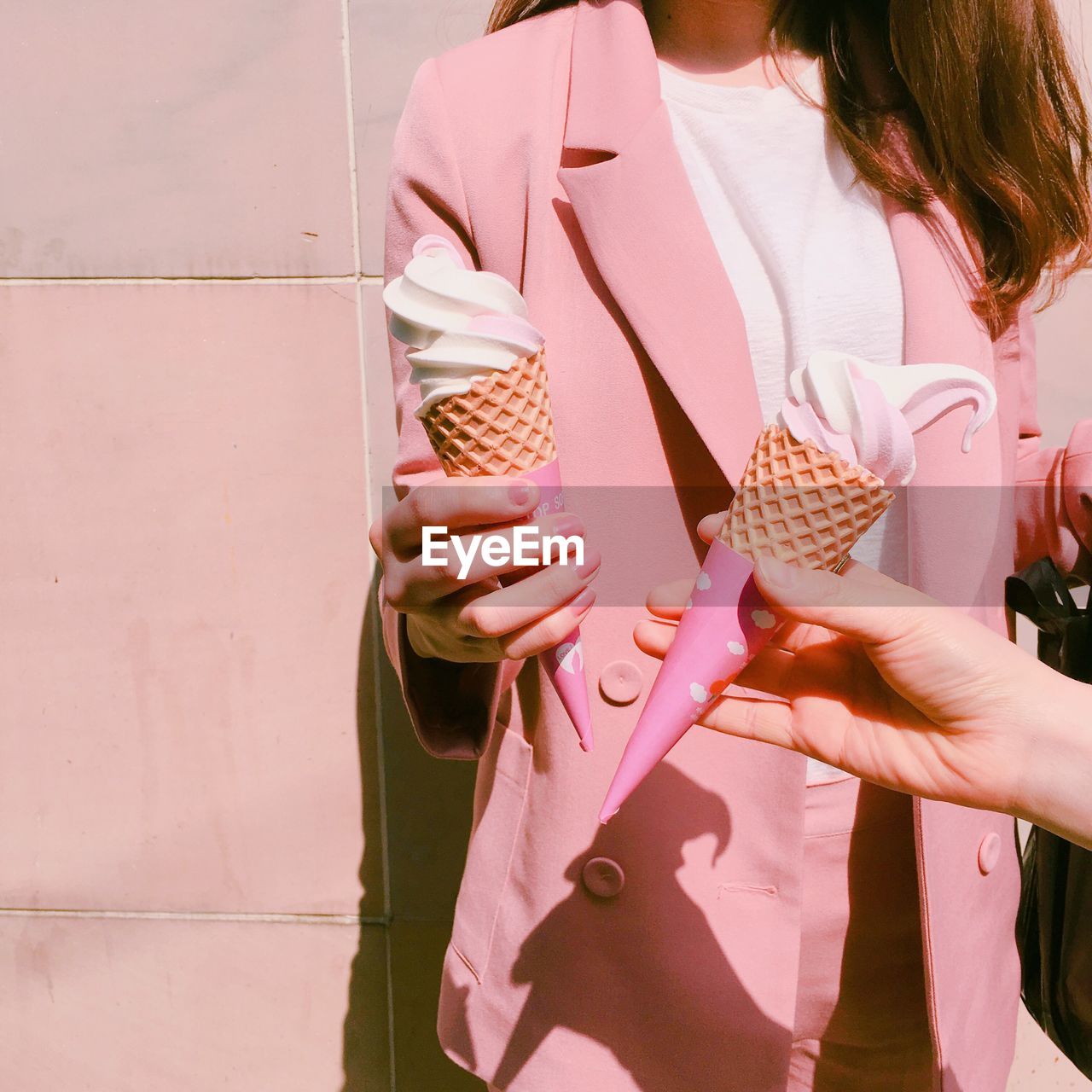 Friends holding ice cream cone