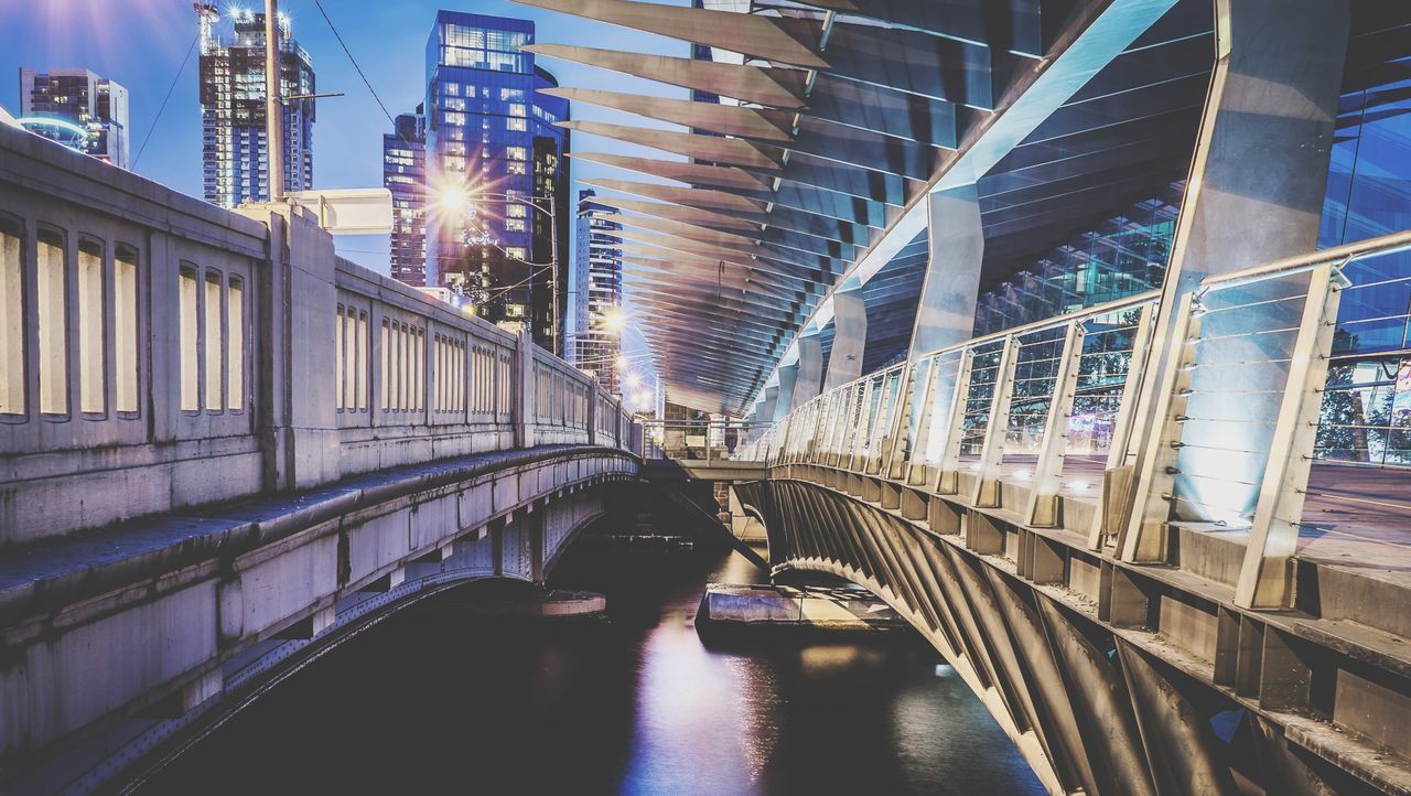 View of footbridge in city at night